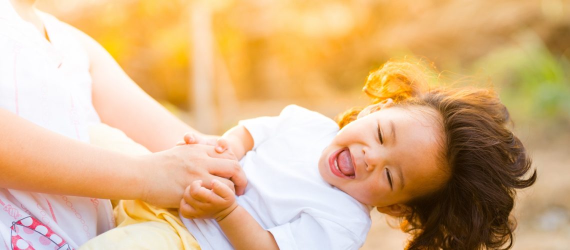 woman-holding-baby-smiling-1116050